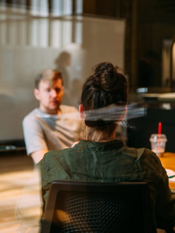person sitting in a chair in front of a man